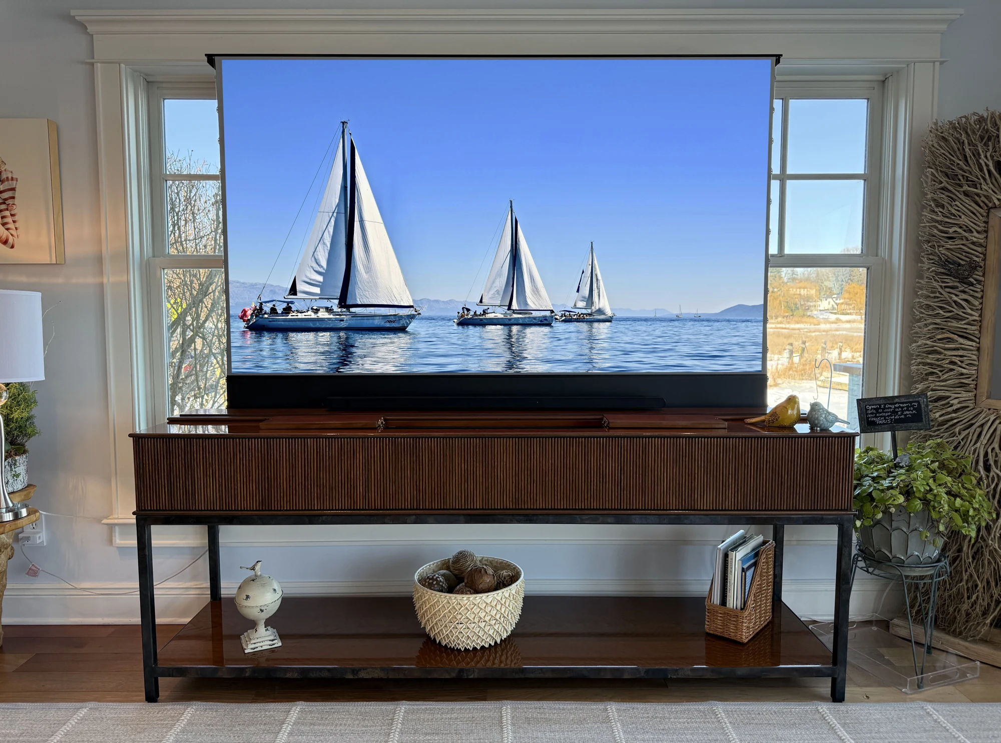 Hudson Table with its projection screen raised in front of a window