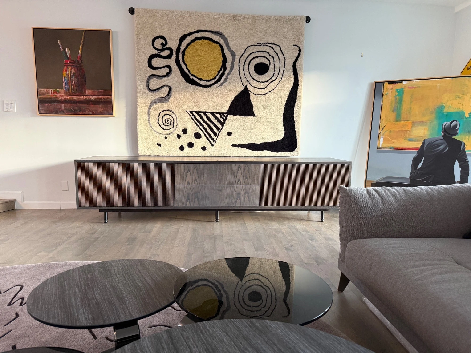 Westport Credenza beneath artwork in a Manhattan living room, with the entertainment system concealed